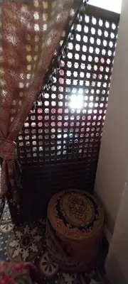 a shower with a wooden seat in a room at Riad lala zakia in Moulay Idriss Zerhoun