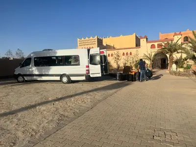 a white van parked in front of a building at Moda Camp merzouga tours Quad Sunboarding ATV in Merzouga
