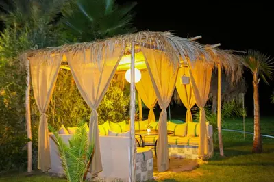 a gazebo with yellow chairs and a table at Weedan Hôtel&Spa Marrakech in Oulad Snaguia