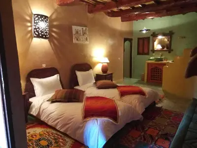 a bedroom with two beds in a room at Dar Amazir in Agdz