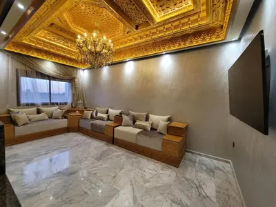 a living room with a couch and a gold ceiling at ZR Comfort Delux in Fès