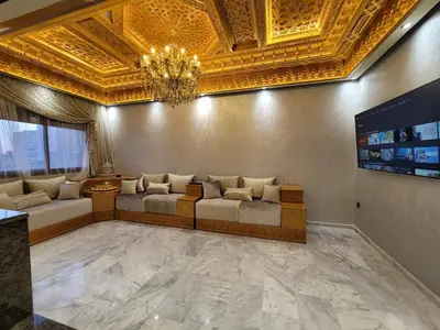a living room with a couch and a gold ceiling at ZR Comfort Delux in Fès