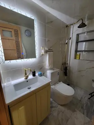a bathroom with a toilet and a sink and a mirror at ZR Comfort Delux in Fès