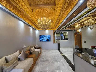 a lobby with a couch and a chandelier at ZR Comfort Delux in Fès