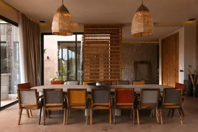 a dining room with a large table and chairs at Palais Nohe in Marrakech