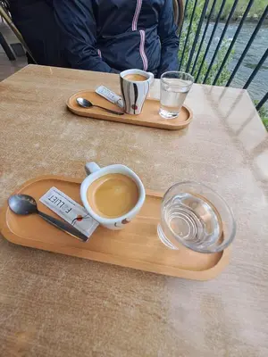 a wooden tray with two cups of coffee on a table at Hôtel Imilchil in Midelt
