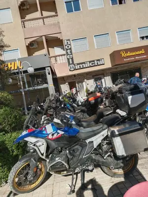 a row of motorcycles parked in front of a building at Hôtel Imilchil in Midelt