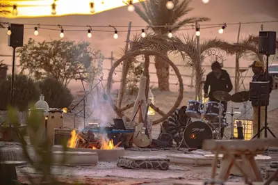 a stage with a fire and a group of instruments at Imperial Glory Lodges in Merzouga