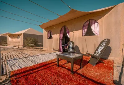 a building with a snowboard on the side of it at Imperial Glory Lodges in Merzouga
