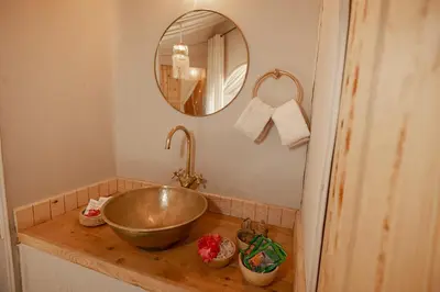 a bathroom with a bowl sink and a mirror at Imperial Glory Lodges in Merzouga