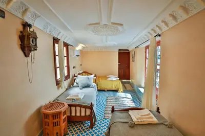 a room with two beds and a room with a bed sidx sidx sidx at Riad Dar Jeanne in Fès