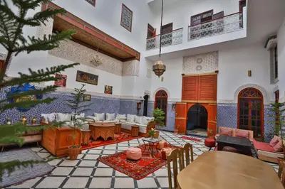 a living room filled with furniture and a christmas tree at Riad Dar Jeanne in Fès