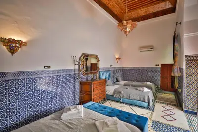 a bedroom with blue and white tiles on the walls at Riad Dar Jeanne in Fès