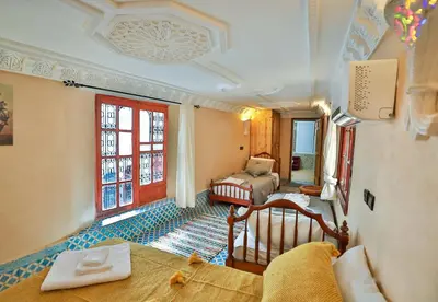 a room with a bedroom with a bed and a window at Riad Dar Jeanne in Fès