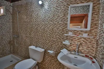 a bathroom with a toilet and a sink and a mirror at Riad Dar Jeanne in Fès