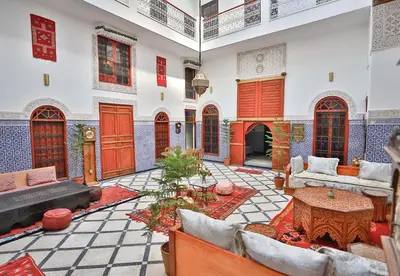 a living room with a couch and a table at Riad Dar Jeanne in Fès