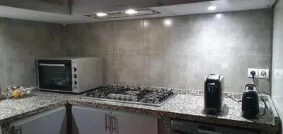 a kitchen with a stove and a microwave on a counter at Darna in Marrakech