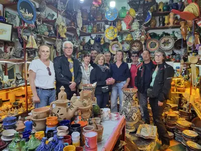 a group of people standing in a shop with ceramics at Motel Ain Mersa in Ifrane
