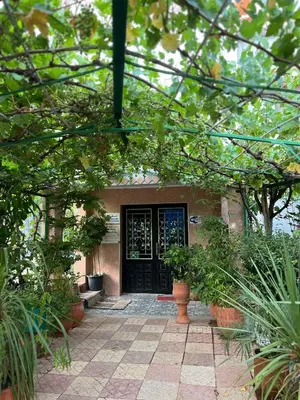 a house with a black door and some plants at Motel Ain Mersa in Ifrane