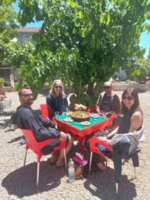 a group of people sitting around a picnic table at Motel Ain Mersa in Ifrane