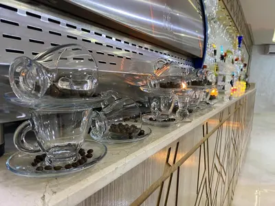 a counter with several glass bowls and cups on it at HOTEL CHARk in Guercif