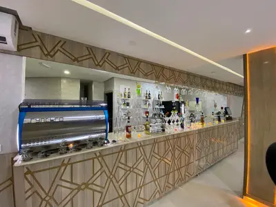 a bar in a hotel room with a counter at HOTEL CHARk in Guercif