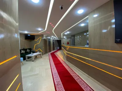a hallway with a red carpet and a bowling alley at HOTEL CHARk in Guercif
