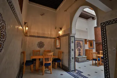a dining room with a table and chairs at Dar Kenz Fes in Fès