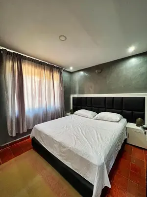 a bedroom with a large bed and a large window at Chalet Snow Valley - Private Pool in Imouzzer Kandar