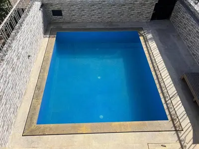 a large blue swimming pool on top of a building at Chalet Snow Valley - Private Pool in Imouzzer Kandar