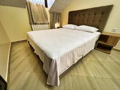 a bedroom with a large bed with white sheets and pillows at Chalet Snow Valley - Private Pool in Imouzzer Kandar