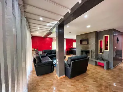 a living room with black chairs and a fireplace at Chalet Snow Valley - Private Pool in Imouzzer Kandar