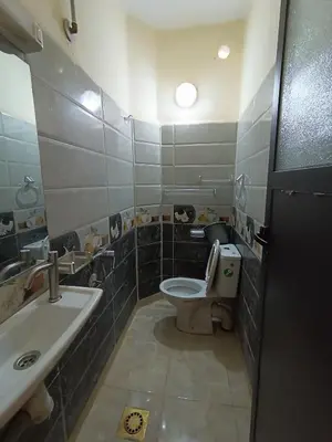 a bathroom with a toilet and a sink at Hotel ASSAFIRE in Bou Mia