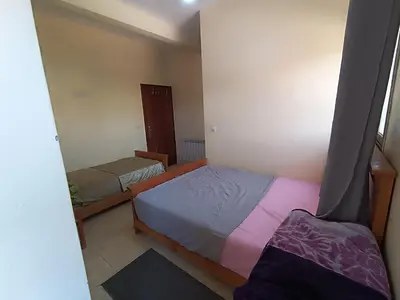 a small bedroom with two beds in a room at Hotel ASSAFIRE in Bou Mia