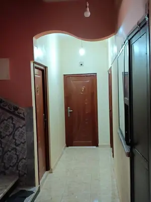 a hallway with a brown door in a room at Hotel ASSAFIRE in Bou Mia