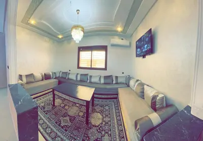 a living room with a couch and a table at Dar Al Montazah in Meknès