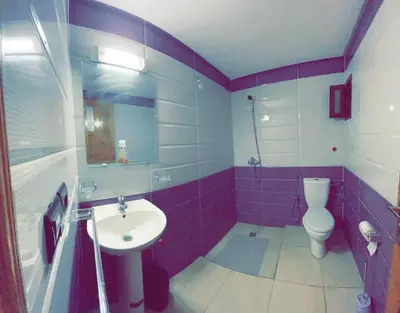 a purple bathroom with a sink and a toilet at Dar Al Montazah in Meknès