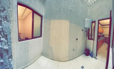 a bathroom with a window and a tiled floor at Dar Al Montazah in Meknès
