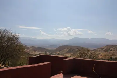 a view of a valley with mountains in the distance at Eco-Lodge IGHAZRAN in Ahermoumou