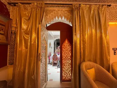 an entrance to a room with gold curtains at Riad Mogador in Meknès