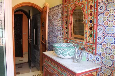 a bathroom with a sink and a mirror at Riad Mogador in Meknès
