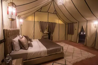 a bedroom with a bed in a tent at Sahara Events Camp in Merzouga