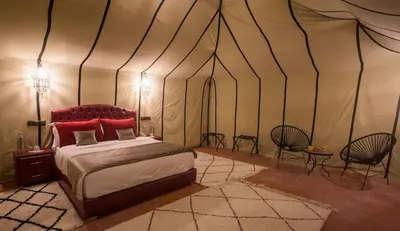 a bedroom with a bed in a tent at Sahara Events Camp in Merzouga
