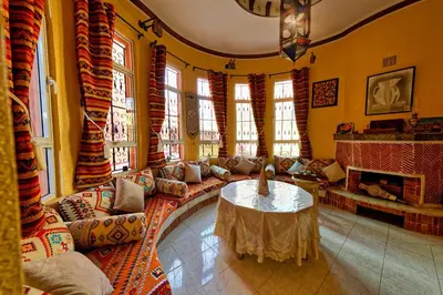 a living room with a couch and a table at Riad Parfums de OUARZAZATE in Ouarzazate