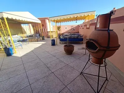 a pot on a stand on a patio at Riad Parfums de OUARZAZATE in Ouarzazate
