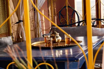 a table with a tea kettle and glasses on it at Riad Parfums de OUARZAZATE in Ouarzazate