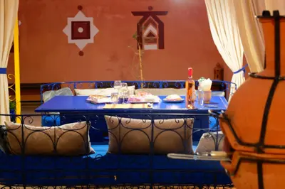 a blue table with chairs and a blue table with food on it at Riad Parfums de OUARZAZATE in Ouarzazate