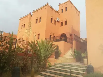 a large building with stairs in front of it at Riad Ouinz in Aït Ben Haddou