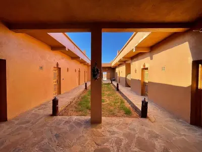 an empty hallway of a building with orange walls at Tigmi Timhar in Tafrourht nʼAït Bou Jijou