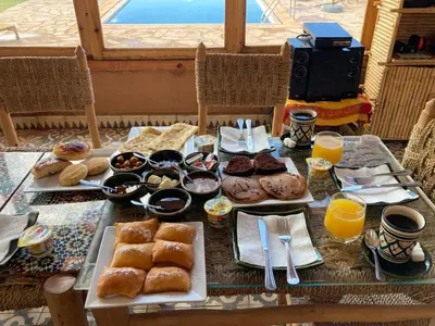 a table full of breakfast foods and orange juice at Tigmi Timhar in Tafrourht nʼAït Bou Jijou
